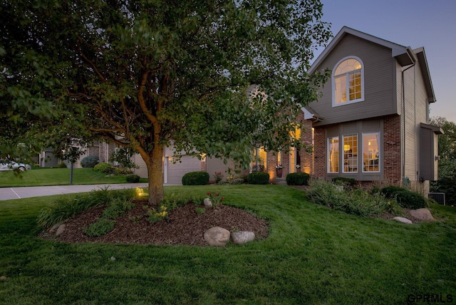 view of property hidden behind natural elements with brick siding, central air condition unit, driveway, and a front yard