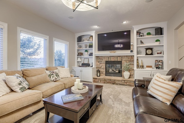 living area featuring built in features and a fireplace