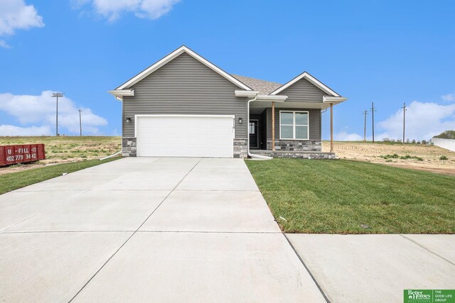 ranch-style house featuring concrete driveway, a front lawn, stone siding, and an attached garage