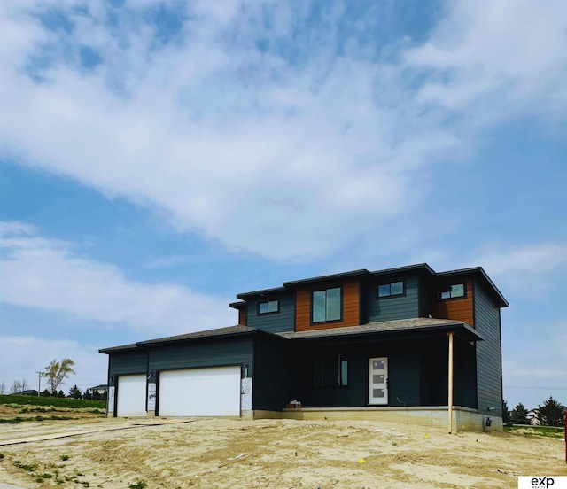 view of front of property with covered porch and a garage
