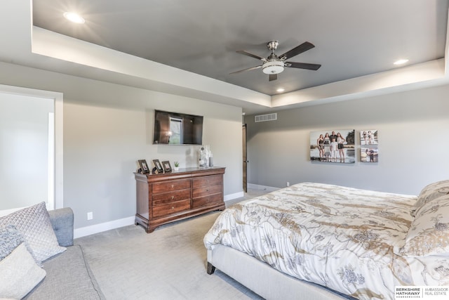 bedroom featuring recessed lighting, baseboards, visible vents, and a raised ceiling