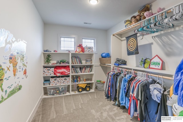 spacious closet featuring visible vents and carpet floors