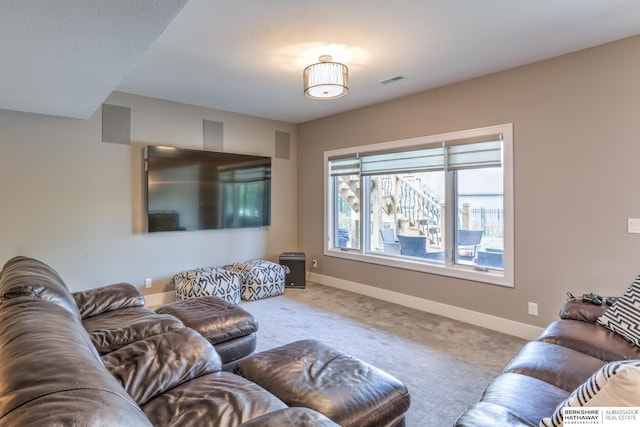 living area featuring visible vents, carpet flooring, and baseboards