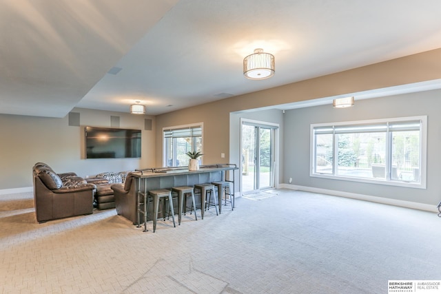 kitchen with open floor plan, baseboards, and carpet floors