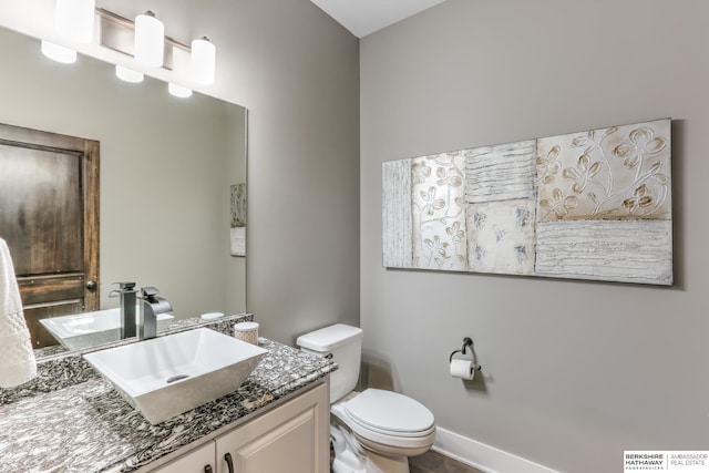 bathroom featuring toilet and vanity