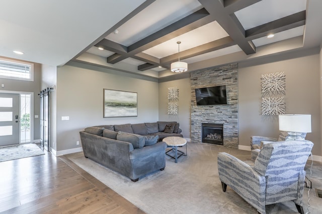 living area with coffered ceiling, beamed ceiling, and baseboards