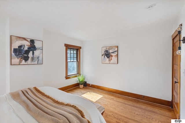 bedroom featuring wood finished floors and baseboards