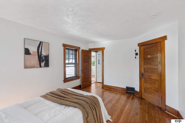 bedroom with baseboards and wood finished floors