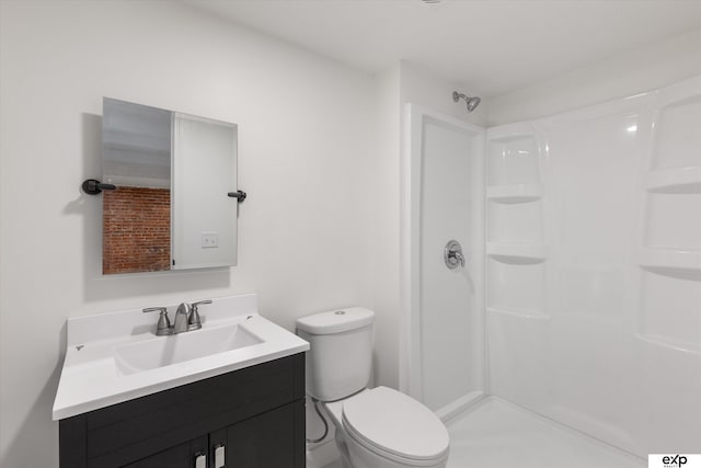 full bath featuring a stall shower, toilet, and vanity
