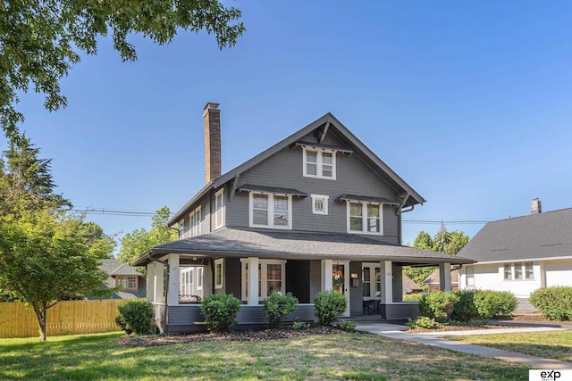 view of front of house featuring a chimney and a porch