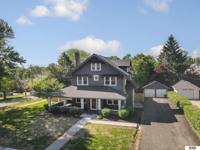 view of front of house featuring a garage, a porch, a front lawn, and roof with shingles