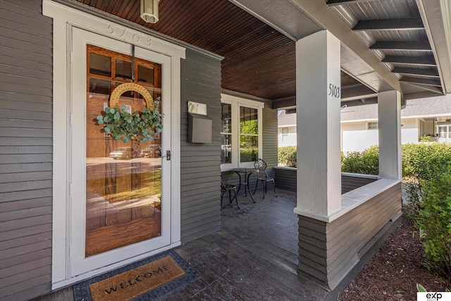 view of exterior entry with a porch