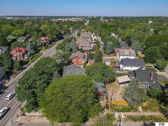 aerial view of property's location with nearby suburban area and a tree filled landscape