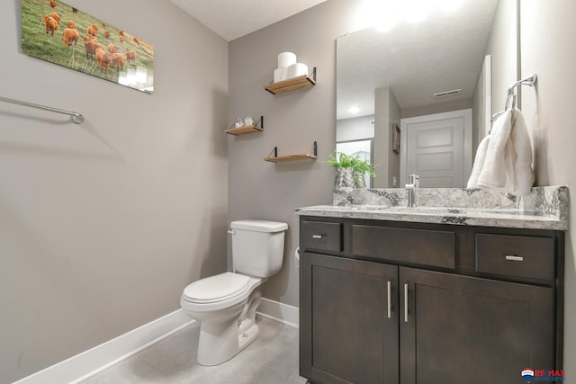 bathroom featuring tile patterned flooring, visible vents, vanity, toilet, and baseboards