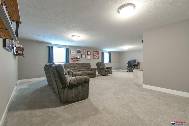 living area featuring baseboards, a textured ceiling, and carpet