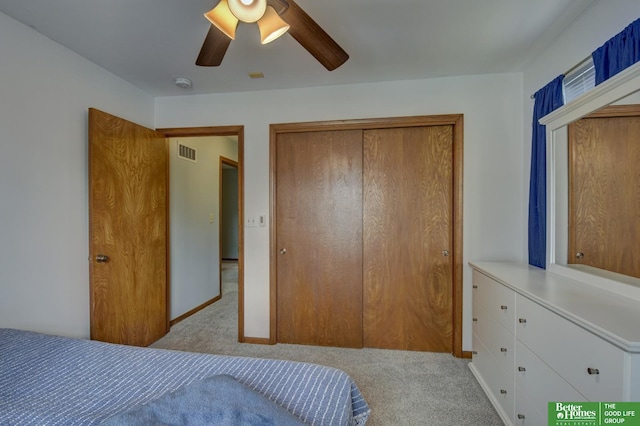 carpeted bedroom featuring baseboards, a ceiling fan, visible vents, and a closet