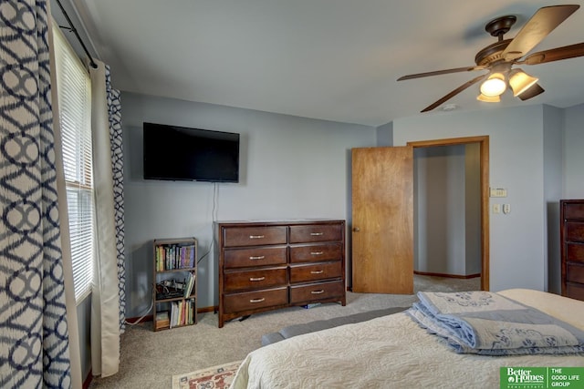bedroom with light carpet, baseboards, and ceiling fan