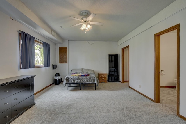 carpeted bedroom featuring baseboards, ceiling fan, and connected bathroom