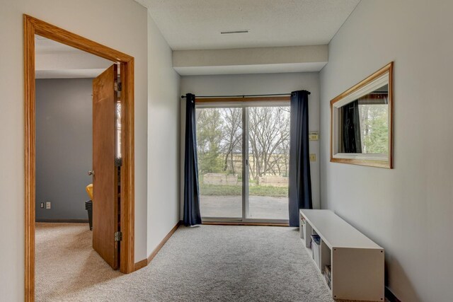 entryway with carpet flooring and baseboards