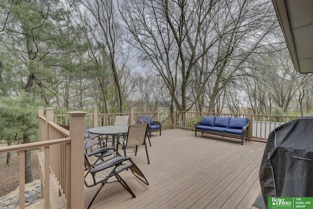 deck featuring outdoor dining space and a grill