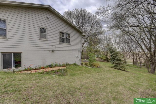 view of home's exterior with a lawn