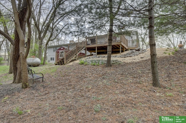 view of yard with a wooden deck and stairs