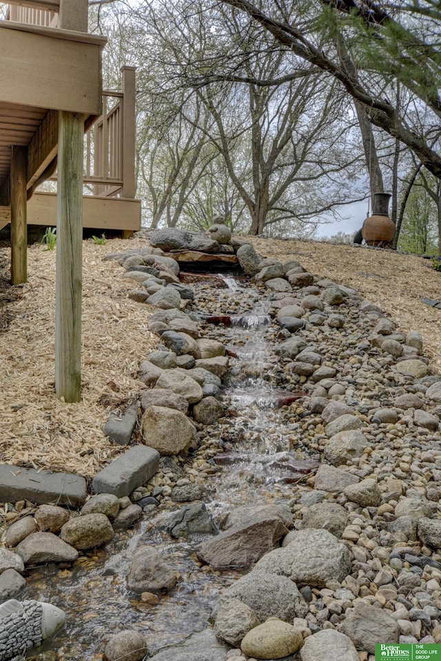 view of yard featuring a deck and stairs