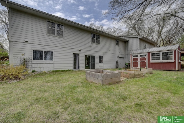 rear view of property with a storage unit, a garden, an outbuilding, and a lawn