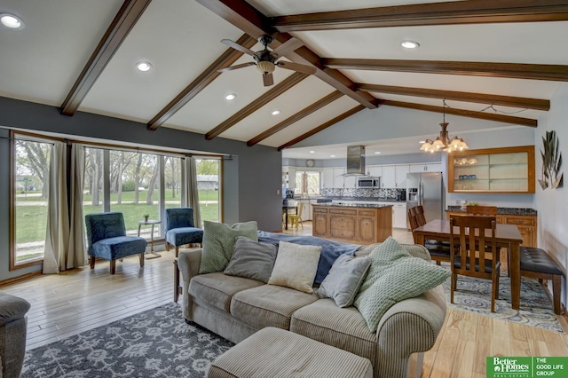 living area featuring ceiling fan with notable chandelier, vaulted ceiling with beams, recessed lighting, and light wood-type flooring