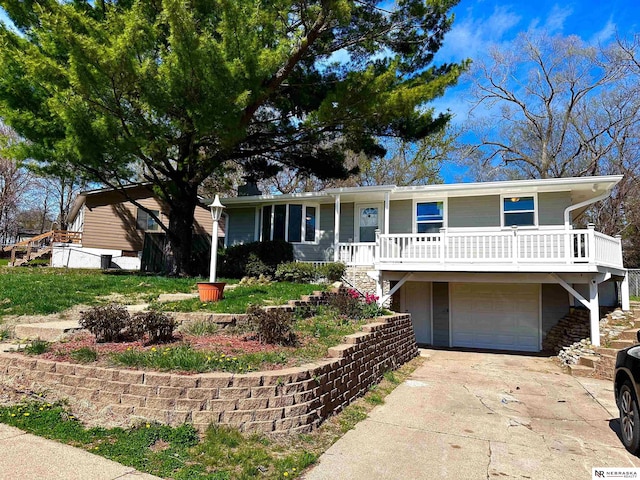 ranch-style home featuring an attached garage, driveway, covered porch, and stairs