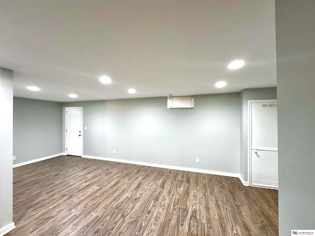 finished below grade area featuring recessed lighting, baseboards, and dark wood-style flooring