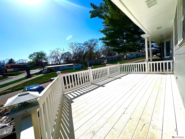 wooden terrace featuring a residential view