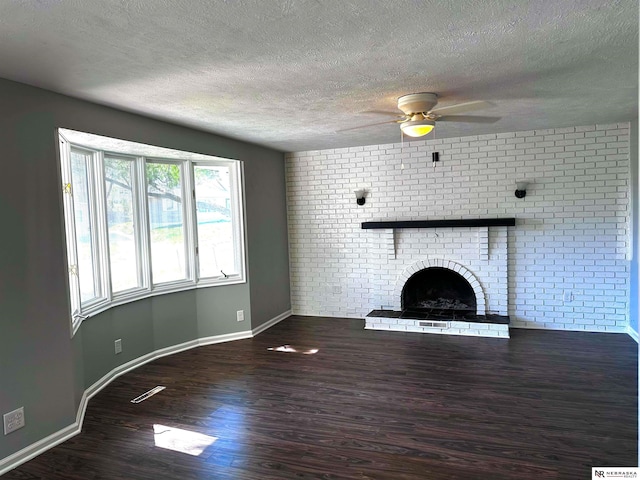 unfurnished living room featuring wood finished floors, a textured ceiling, ceiling fan, a fireplace, and baseboards
