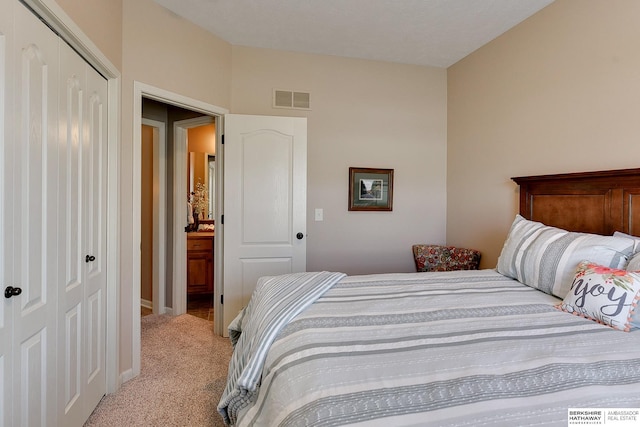 bedroom with baseboards, visible vents, a closet, and light colored carpet