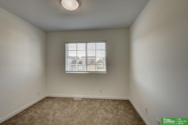 unfurnished room with baseboards, visible vents, and carpet