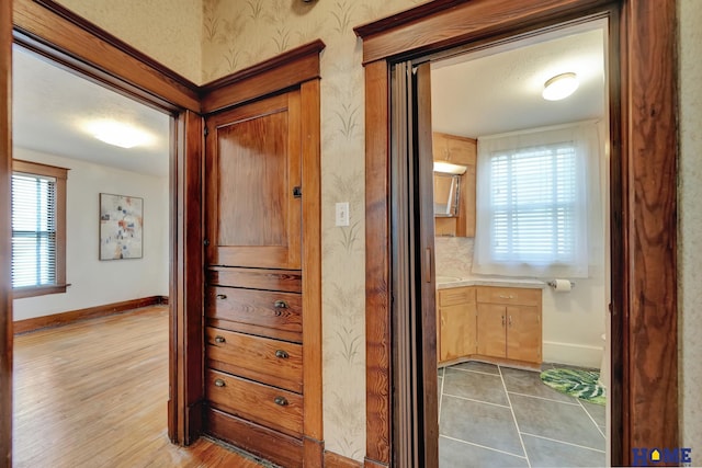 hall with wood finished floors and baseboards