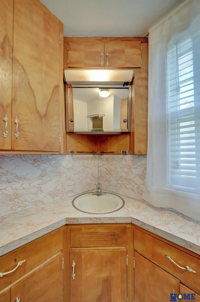 bathroom with tasteful backsplash and vanity