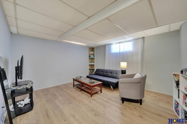living area with baseboards and wood finished floors
