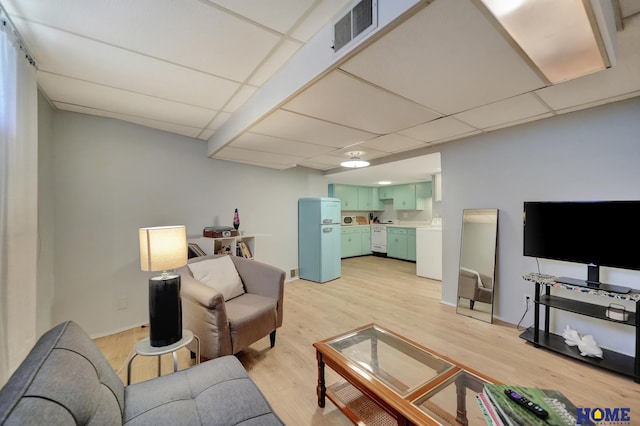 living room with light wood finished floors, a drop ceiling, and visible vents
