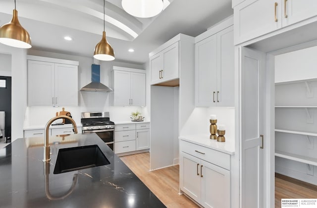 16951 Benjamin St, Bennington, NE 68007 - kitchen with wall chimney exhaust hood, stainless steel gas range oven, a sink, light wood finished floors, and recessed lighting