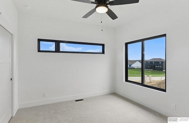 16951 Benjamin St, Bennington, NE 68007 - unfurnished bedroom with light carpet, baseboards, and a ceiling fan