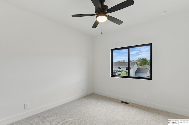 16951 Benjamin St, Bennington, NE 68007 - spare room with light colored carpet, baseboards, and a ceiling fan