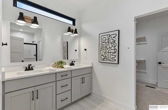 16951 Benjamin St, Bennington, NE 68007 - bathroom featuring baseboards, double vanity, and a shower