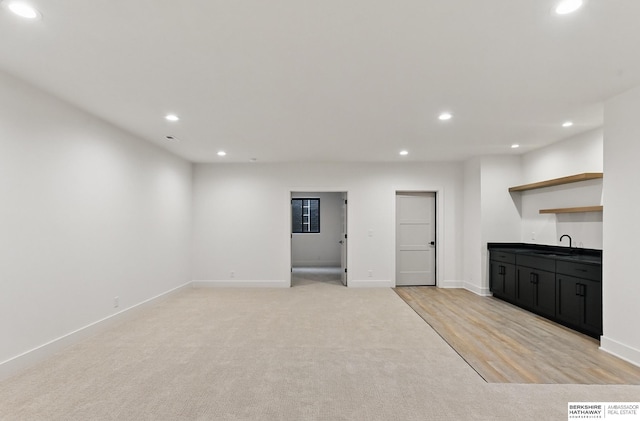 16951 Benjamin St, Bennington, NE 68007 - unfurnished living room featuring recessed lighting, wet bar, baseboards, and light colored carpet