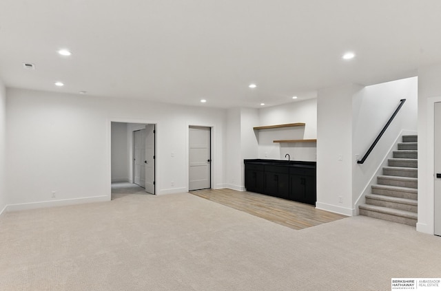 16951 Benjamin St, Bennington, NE 68007 - unfurnished living room with light colored carpet, wet bar, recessed lighting, stairway, and baseboards
