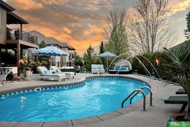 view of pool with a patio area, a fenced in pool, and an outdoor living space