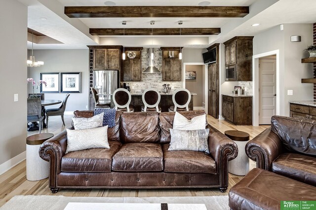living room featuring light wood-style floors, an inviting chandelier, baseboards, beam ceiling, and recessed lighting