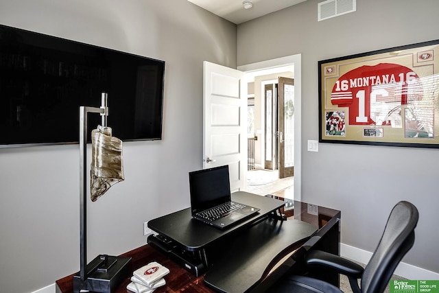 office area with baseboards, visible vents, and a wealth of natural light