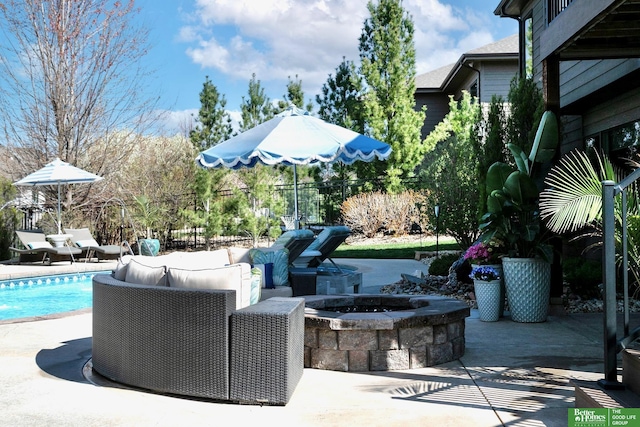 view of patio with a fire pit, a fenced in pool, and fence