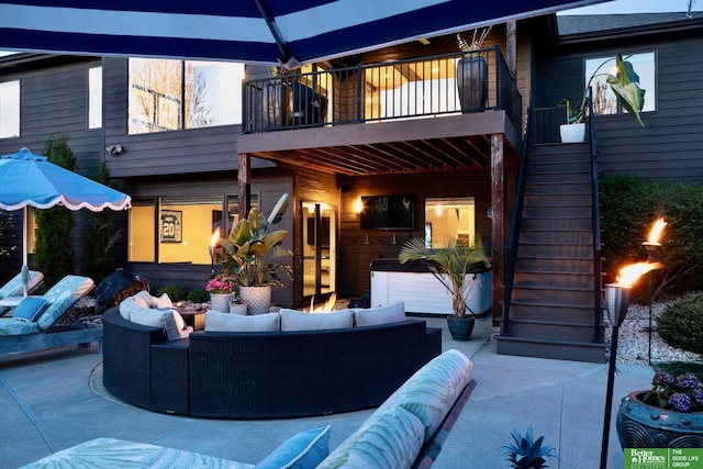 back of house featuring outdoor lounge area, a patio, stairs, and a balcony